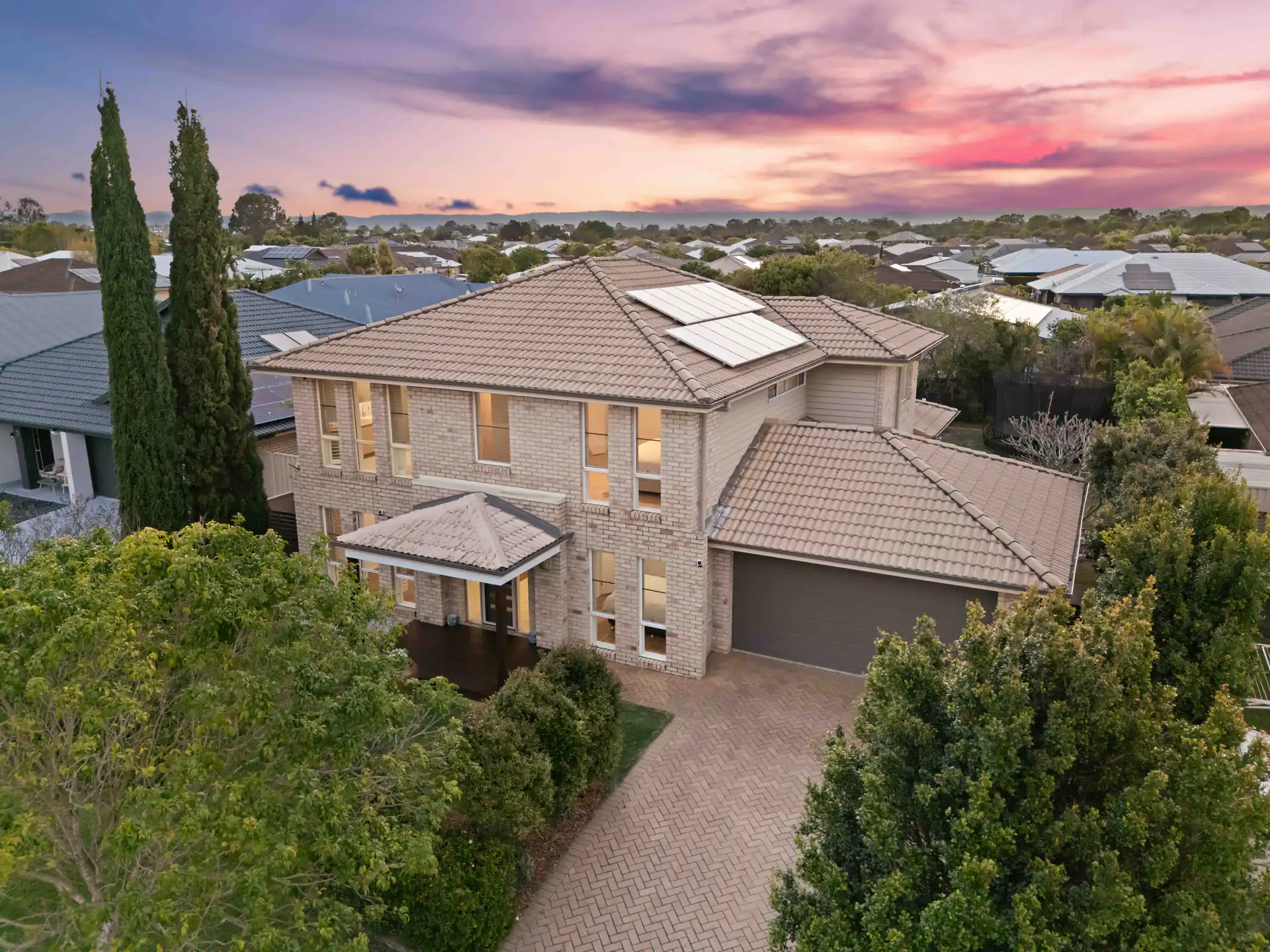 Drone photography of a two-storey home at twilight