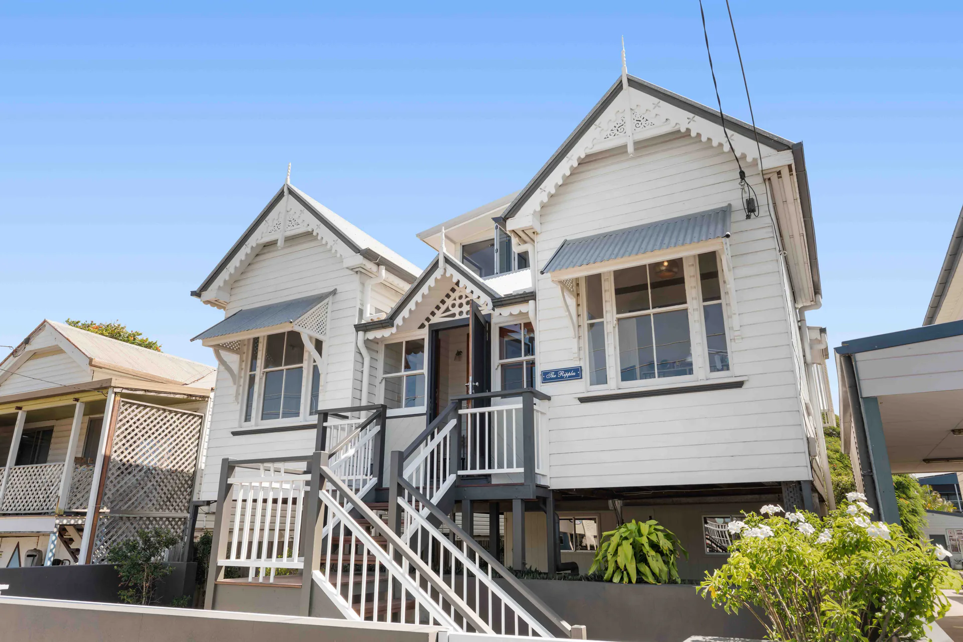 Listing photography of a white Queenslander home exterior