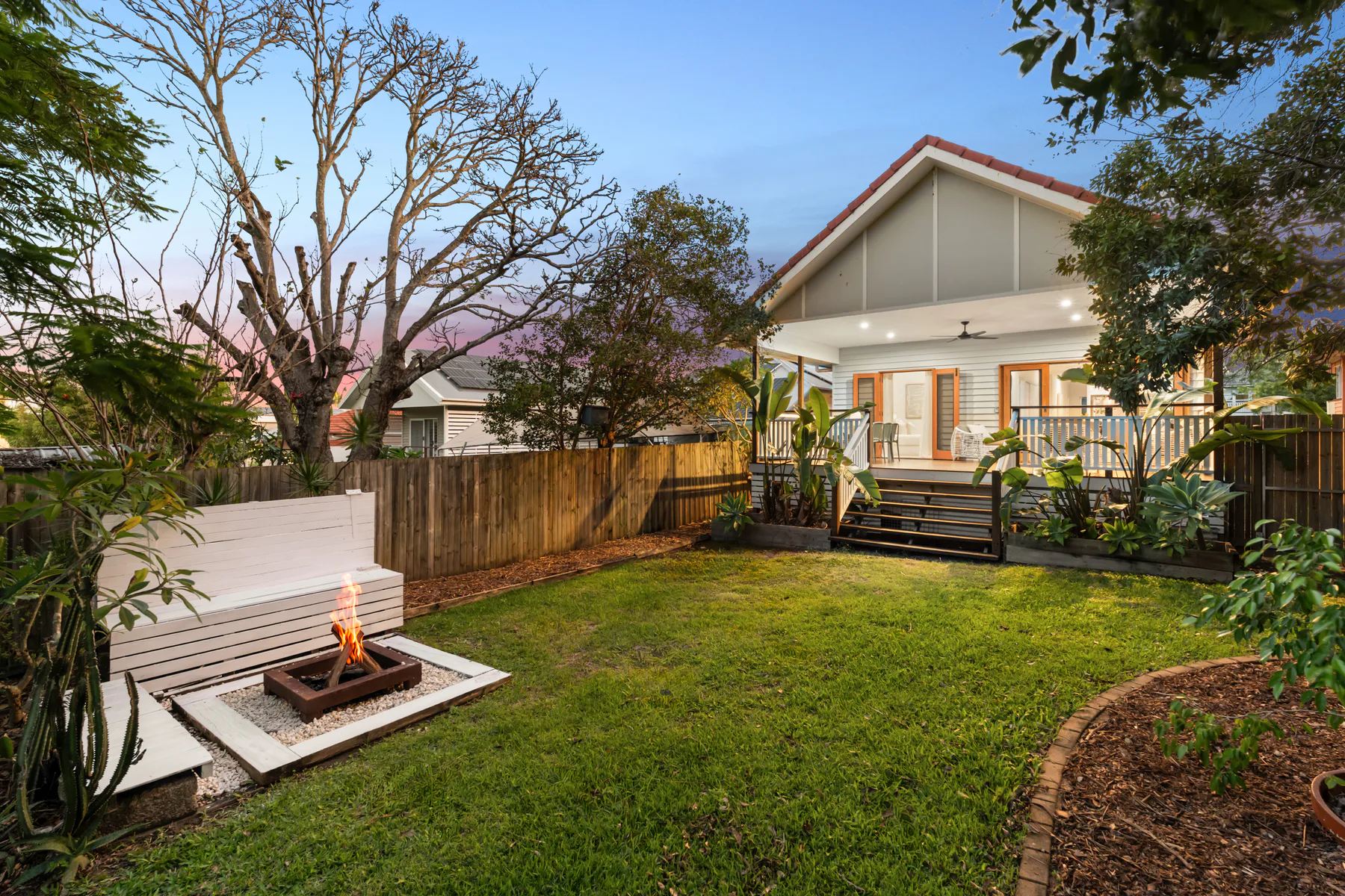 Twilight garden and fire pit at a Brighton home