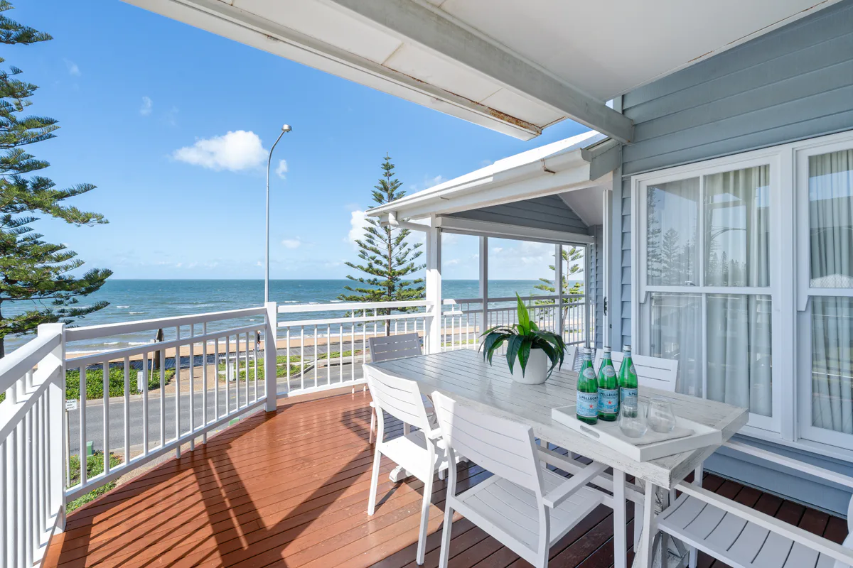 Ocean-facing covered deck with outdoor dining