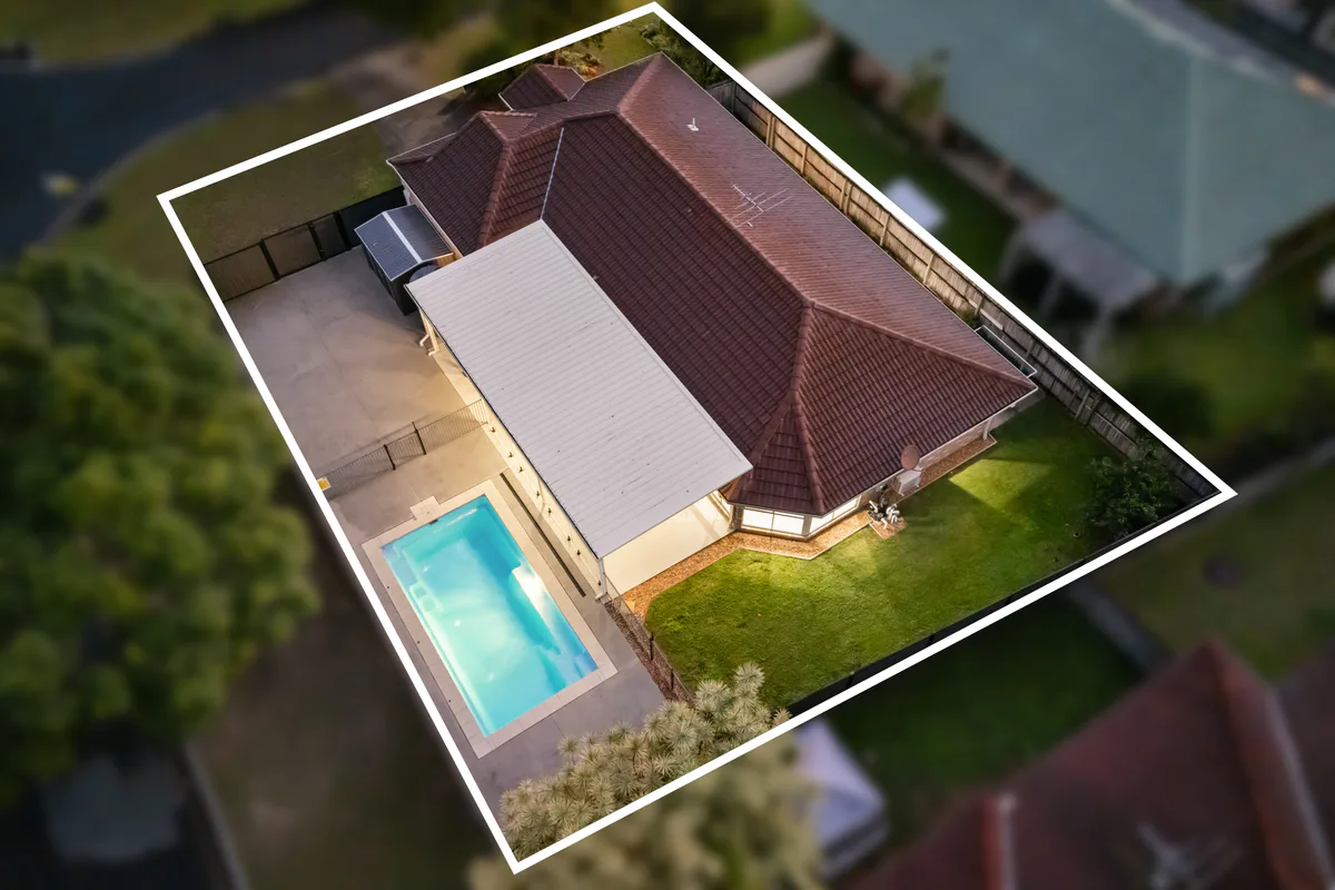 Aerial photograph of a home with its property boundary marked